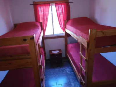 two bunk beds in a small room with a window at Wikam in Cordoba