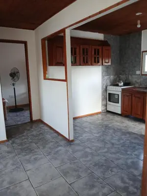 a kitchen with a white refrigerator and a stove at Wikam in Cordoba