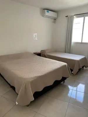 two beds sitting next to each other in a room at departamentos apart quetzal in Villa Carlos Paz