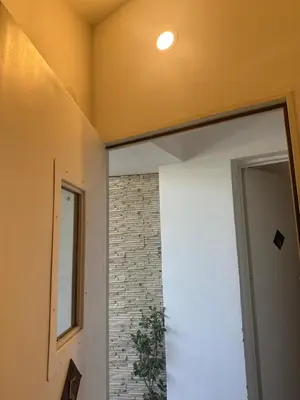 a room with a door and a brick wall at departamentos apart quetzal in Villa Carlos Paz