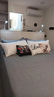a bed with some pillows on top of it at Anima Lodge in Villa Carlos Paz