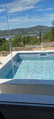 a swimming pool with a view of the water at Anima Lodge in Villa Carlos Paz