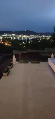 a view of a patio at night with lights at Anima Lodge in Villa Carlos Paz