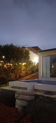 a house with a toilet in front of a window at Anima Lodge in Villa Carlos Paz