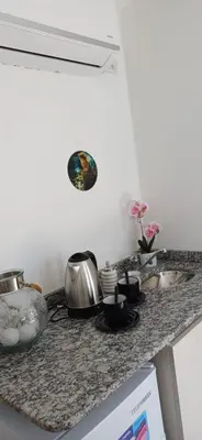 a kitchen counter with a sink and some pots and pans at Anima Lodge in Villa Carlos Paz