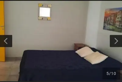 a bedroom with a bed with a blue blanket and a window at San Antonio de Arredondo in San Antonio de Arredondo