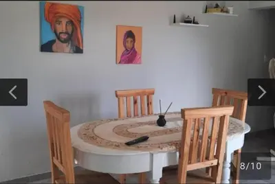 a dining room table with two chairs and a painting at San Antonio de Arredondo in San Antonio de Arredondo