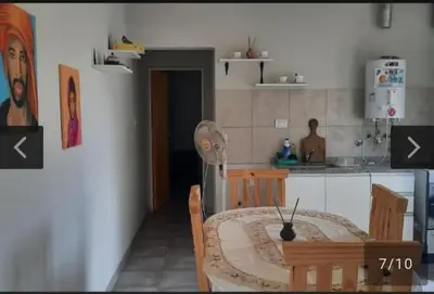 a kitchen with a table and two chairs and a kitchen with a counter at San Antonio de Arredondo in San Antonio de Arredondo