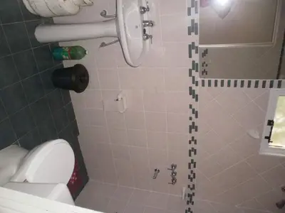 a bathroom with a shower with a white toilet at Casa Cali in Tanti Nuevo