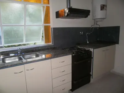a kitchen with a black stove and a sink at Casa Cali in Tanti Nuevo