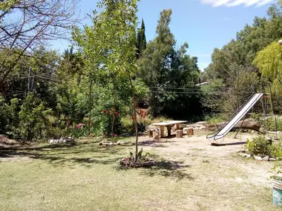 a garden with a picnic table and a tree at Casa Cali in Tanti Nuevo