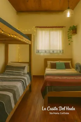 a bedroom with two beds and a window at La Casita del Hada in Santa María