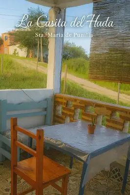 a table and a bench and a table and chair at La Casita del Hada in Santa María