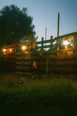 a wooden fence with lights on it at night at La Casita del Hada in Santa María