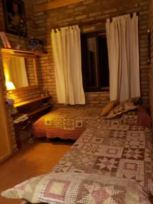 a bedroom with a bed and a window at Casa de Campo in Santa Rosa de Calamuchita