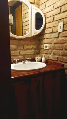a bathroom with a sink and a mirror at Casa de Campo in Santa Rosa de Calamuchita