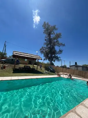 a large swimming pool with a gazebo at Estación La Perla in Alta Gracia