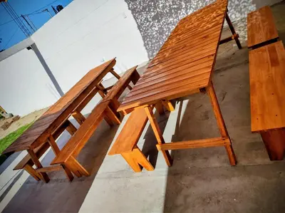 two wooden benches sitting next to each other at Estación La Perla in Alta Gracia