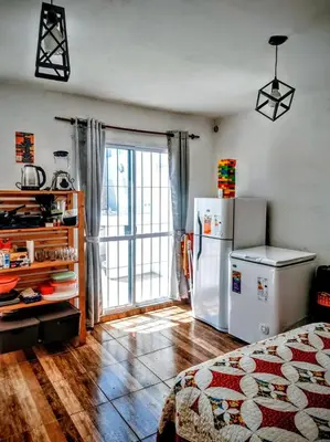 a kitchen with a white refrigerator in a room at Estación La Perla in Alta Gracia