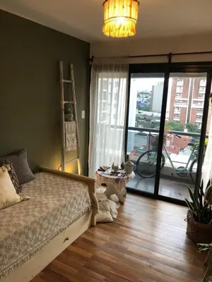 a bedroom with a bed and a large window at Apartment with pool in Cordoba