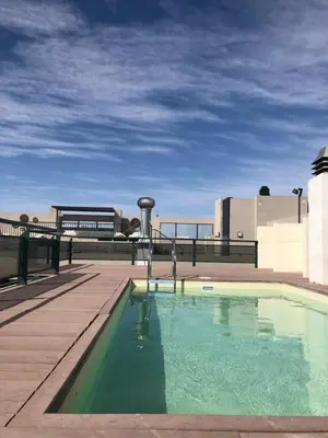 a swimming pool on the roof of a building at Apartment with pool in Cordoba