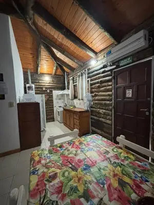 a bedroom with a large bed in a house at Cabañas La Lila in Santa Rosa de Calamuchita