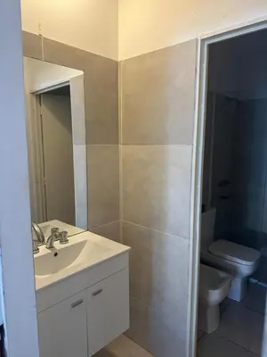 a bathroom with a sink and a toilet at Quetzal Apart Central Apartment N 3 in Villa Carlos Paz