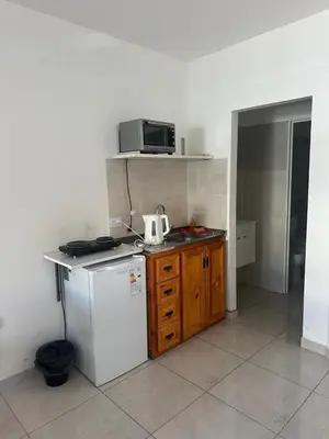 a kitchen with a white refrigerator and a microwave at Quetzal Apart Central Apartment N 3 in Villa Carlos Paz