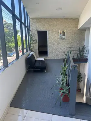 a lobby of a building with a couch and a chair at Quetzal Apart Central Apartment N 3 in Villa Carlos Paz