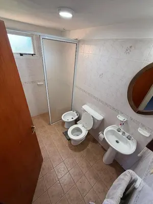 a bathroom with a toilet and a sink at Cabañas Lomas del mirador in Villa del Dique