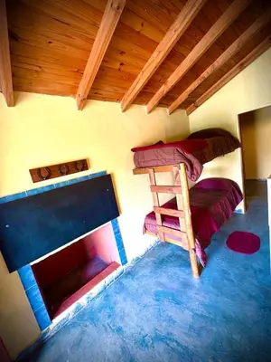 a room with two bunk beds and a fireplace at Koonex in Los Reartes