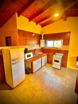 a kitchen with a white refrigerator and a stove at Koonex in Los Reartes