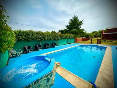 a swimming pool with chairs in a yard at Koonex in Los Reartes