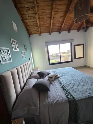 a large bed in a room with a window at havendq in Villa General Belgrano