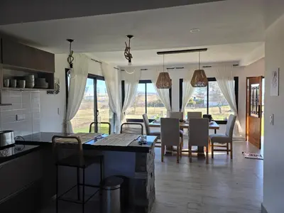 a kitchen and dining room with a table and chairs at havendq in Villa General Belgrano