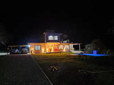a house at night with a car parked in front of it at havendq in Villa General Belgrano