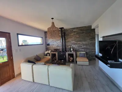 a living room with a couch and a television at havendq in Villa General Belgrano