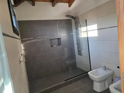 a bathroom with a shower and a toilet at havendq in Villa General Belgrano