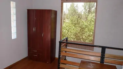 a staircase with a window and a wooden cabinet at CastelAnte in Villa Carlos Paz