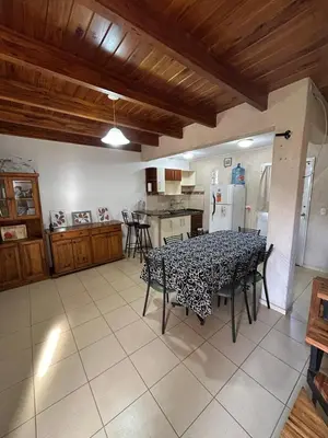 a dining room with a table and a kitchen at CastelAnte in Villa Carlos Paz