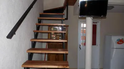 a set of stairs with a television on the top at CastelAnte in Villa Carlos Paz