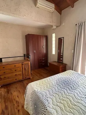 a bedroom with a bed and a dresser in it at CastelAnte in Villa Carlos Paz