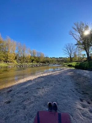 a pair of shoes sitting on the ground next to a river at CastelAnte in Villa Carlos Paz