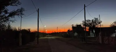 a dirt road with a sunset in the background at Antar Mouna in Cortaderas