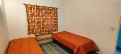 a small room with two beds and a window at Antar Mouna in Cortaderas