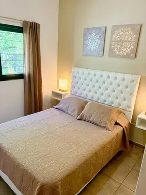 a bedroom with a large bed and a window at Complejo Baren in Villa Ciudad Parque