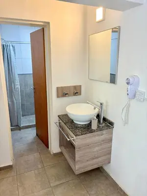 a bathroom with a sink and a mirror at Complejo Baren in Villa Ciudad Parque
