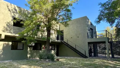 a house with a staircase on the side of it at Complejo Baren in Villa Ciudad Parque