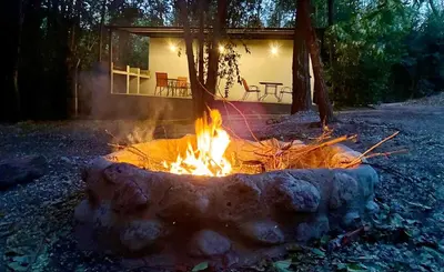 a fire pit in front of a house at Complejo Baren in Villa Ciudad Parque