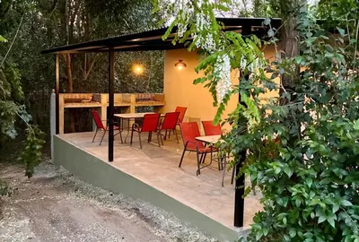 a patio with chairs and a table in a building at Complejo Baren in Villa Ciudad Parque